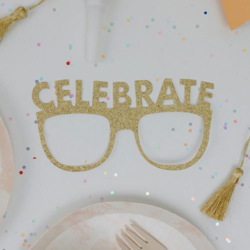 pexels-photo-7723815-7723815 Flat lay of golden glitter 'Celebrate' glasses and confetti on a party table.